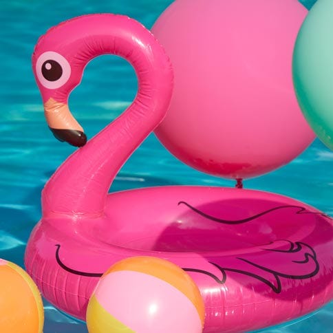 Inflatable tree and flamingo in a garden